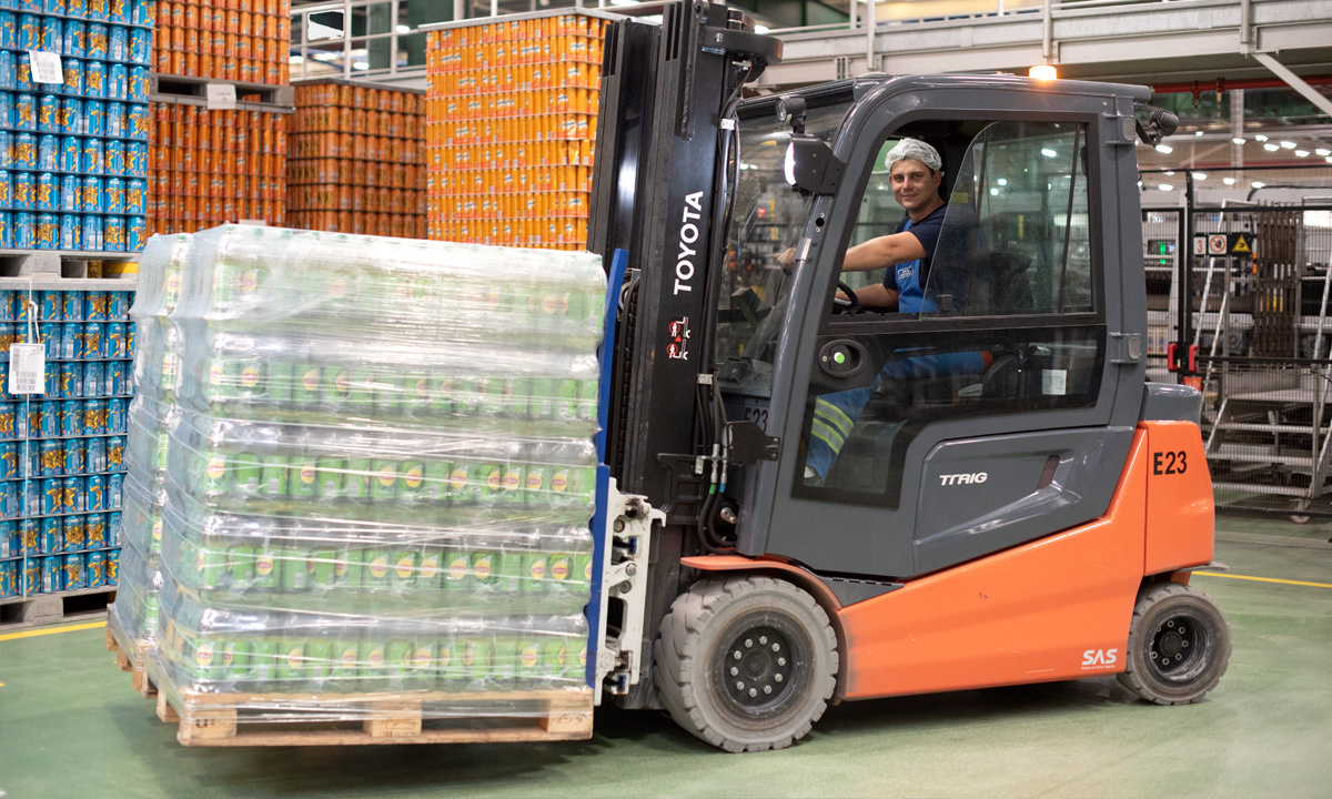 An associate moving PepsiCo products in a manufacturing plant