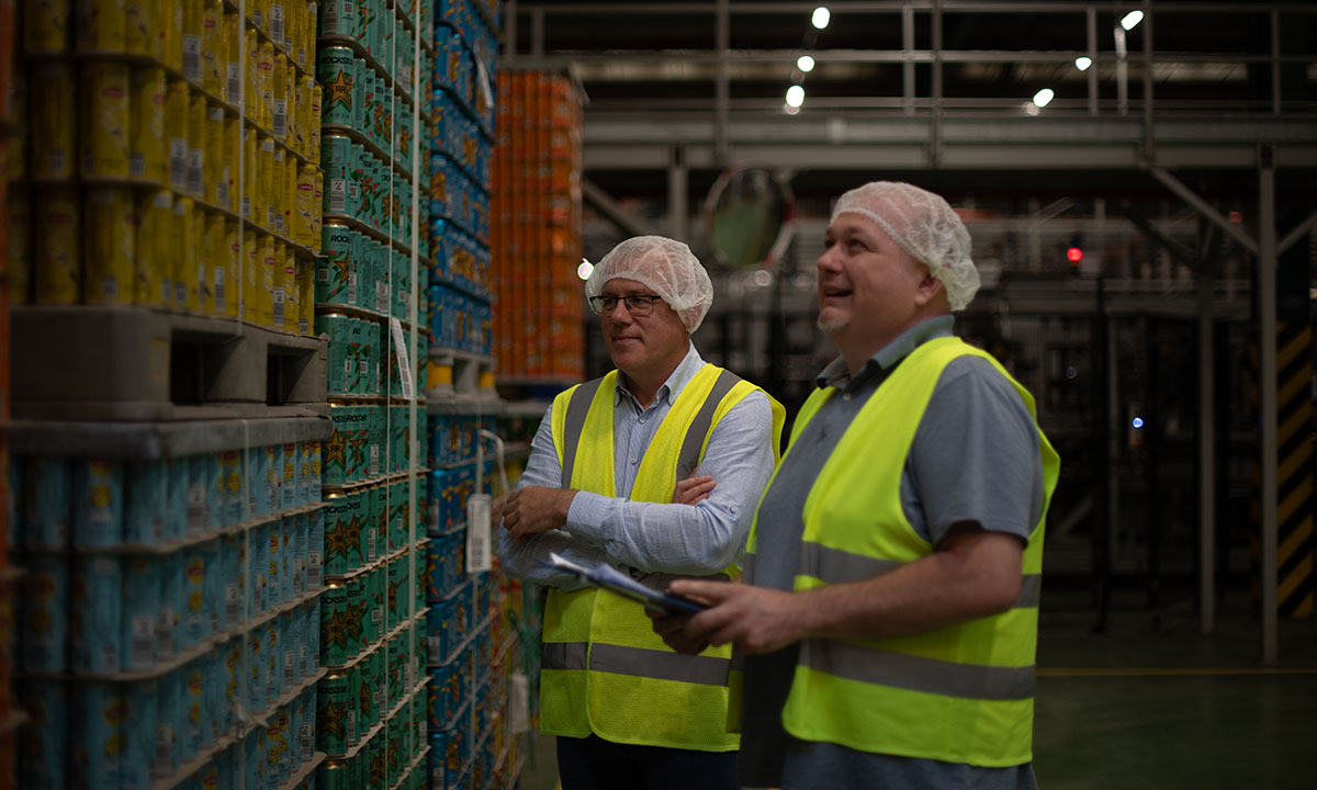 Two associates looking over products in a manufacturing plant