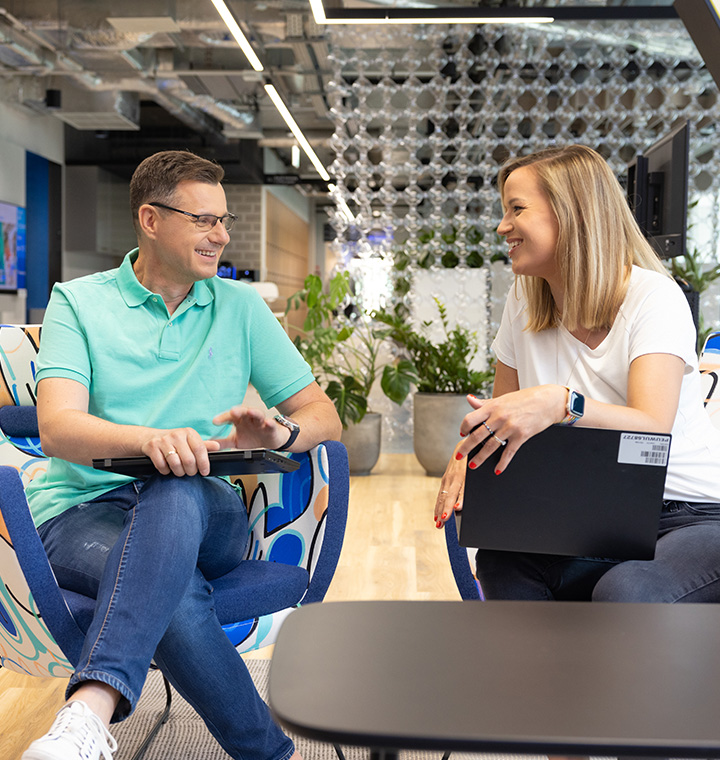 Two associates sitting and talking in an office