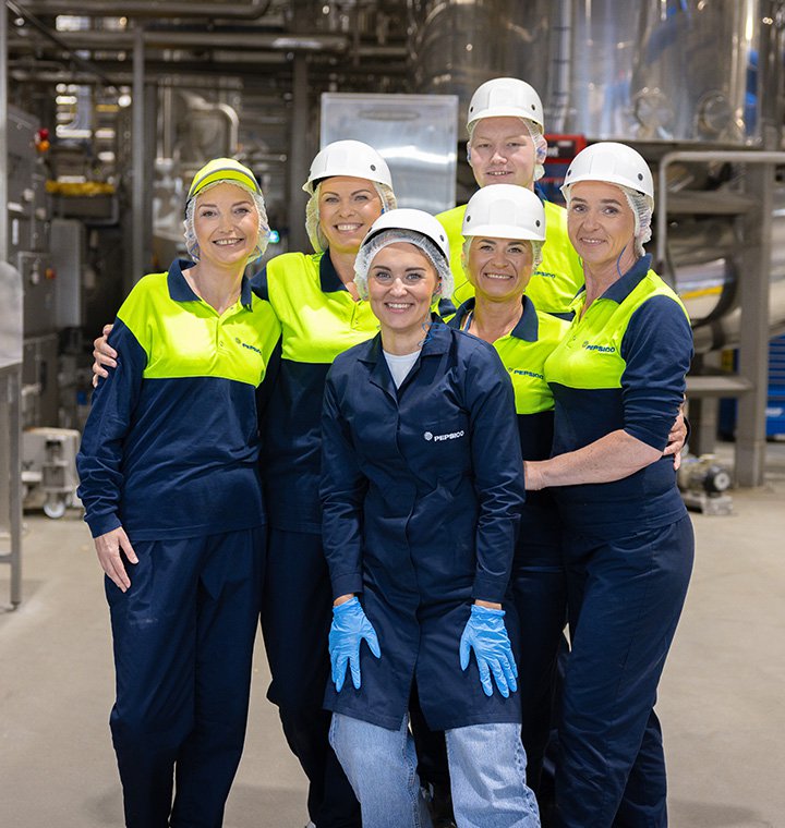 Associates gathered together in a manufacturing plant