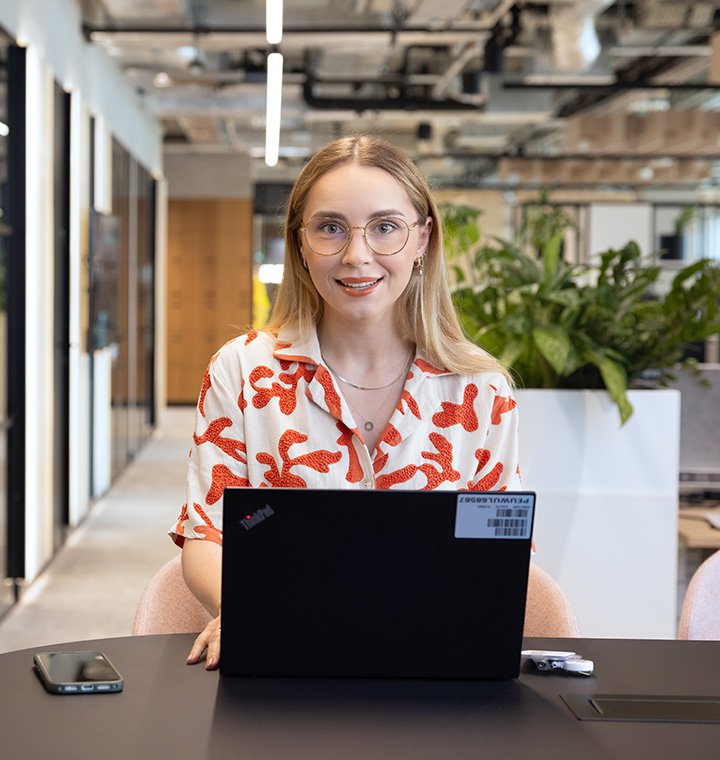 Female associate sitting behind a computer in an office