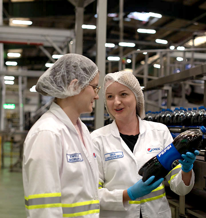 Associates inspecting a bottle of Pepsi